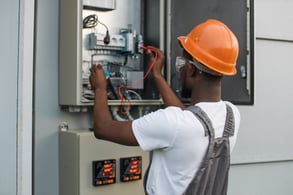 repairman-checking-cables-in-solar-power-transformer